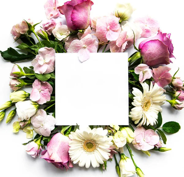 Pink roses and  flowers in  frame with white square for text  on white background