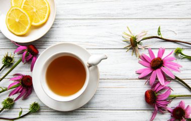 Echinacea tea with lemon and fresh flowers.  clipart