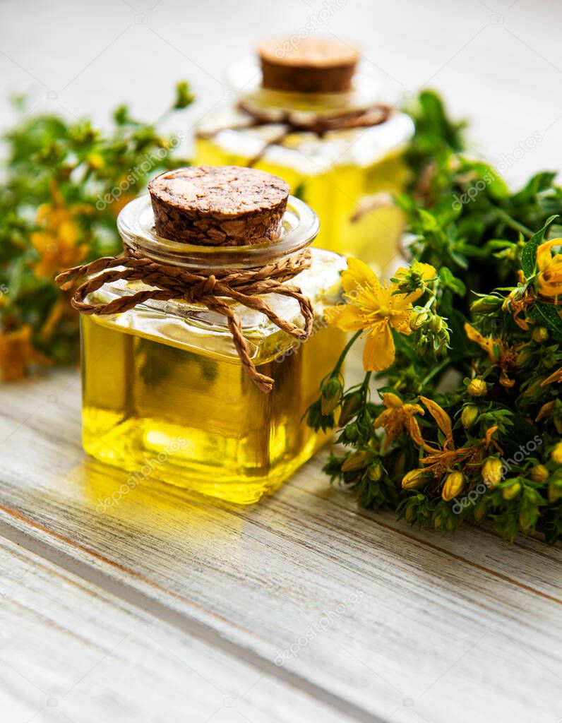 Bottles with St. John's wort extract on the wooden table