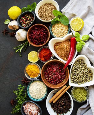 Siyah beton arka planda bir kasede çeşitli baharatlar. Üst görünüm kopyalama alanı.