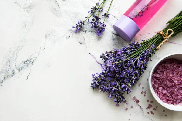 Natural herb cosmetic with lavender,  flatlay on white marble background,  top view