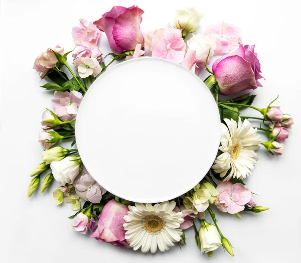 Pink roses and  flowers in round frame with white circle for text  on white background
