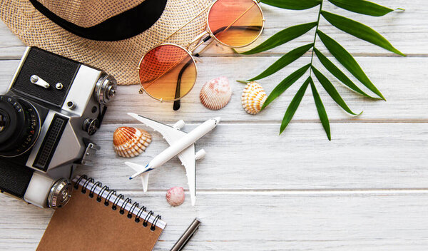 Summer holiday background, travel concept with camera on wooden table background. Flat lay