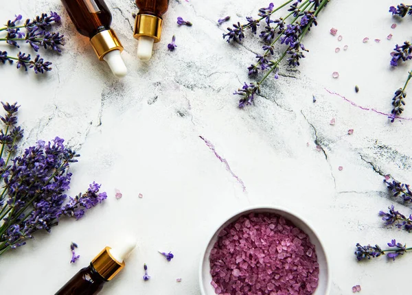 Natural herb cosmetic with lavender,  flatlay on white marble background,  top view