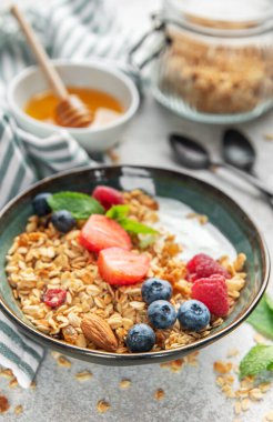 Granola, yogurt, and fresh berries creating a healthy and nutritious breakfast meal