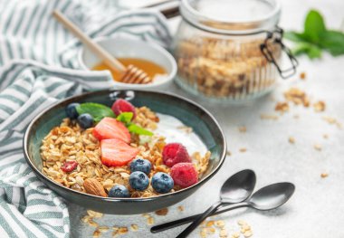 Granola, yogurt, and fresh berries creating a healthy and nutritious breakfast meal