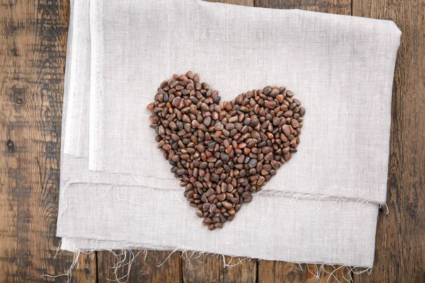 Pine Nuts Shell Arranged Heart Shape Wooden Table Top View — Stock Photo, Image