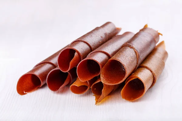 Apple and plum fruit leather rolls. Fruit candy - pastille. Healthy snack.
