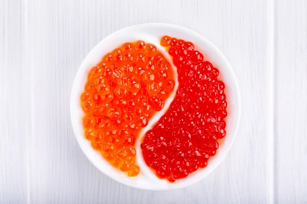 Different types of red caviar on white. Fish caviar, seafood.