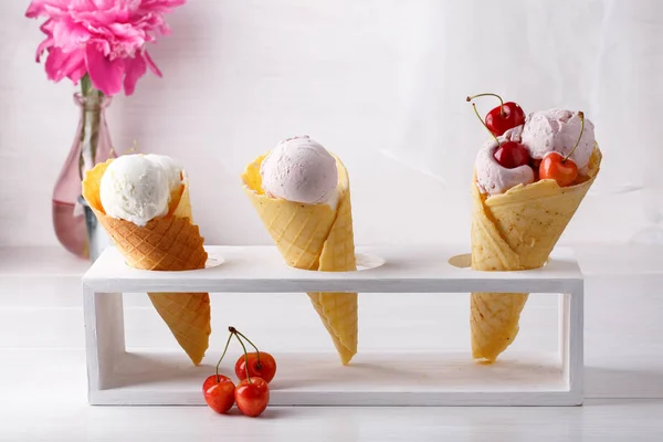 Vanilla ice cream in three waffle cones decorated with sweet che — Stock Photo, Image