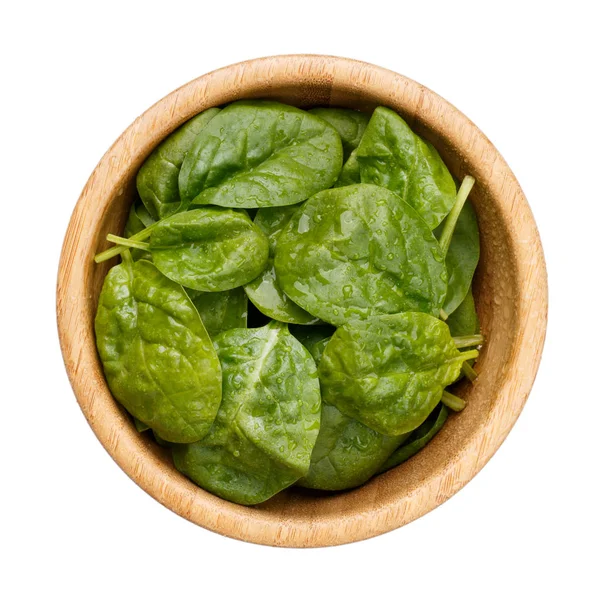Baby spinach leaves in wooden bowl isolated on white background. — Stock Photo, Image