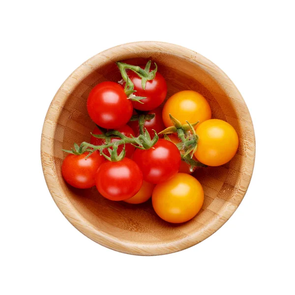 Kırmızı ve sarı küçük kiraz domates ahşap kase izole 
