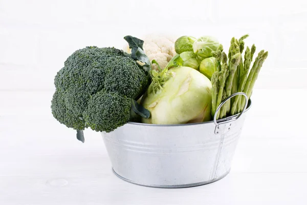 Assortment green vegetables on white table.  Broccoli, cauliflow — Stock Photo, Image