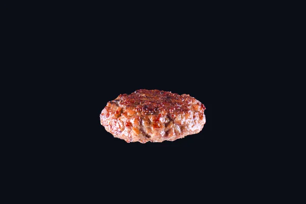 Fried fresh large beef burger isolated on white background. Grilled burger cutlet isolated on black — Stock Photo, Image