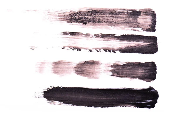 Conjunto de traços pretos de rímel sobre um fundo branco. Textura de rímel preto para pestanas isoladasem branco. Mancha de rímel preto de pestanas. rímel preto ou manchas de tinta — Fotografia de Stock
