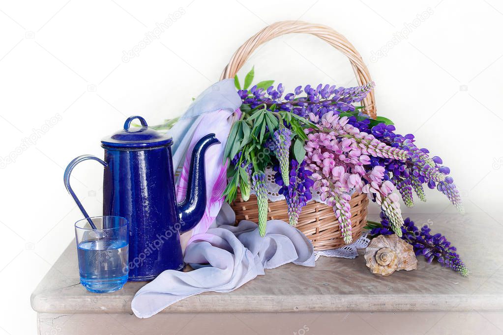 Beautiful bouquet of lupins in a basket isolated on white background