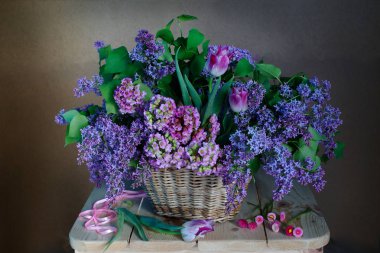Kahverengi bir arka plan üzerinde bir sepette mor bahar buket.