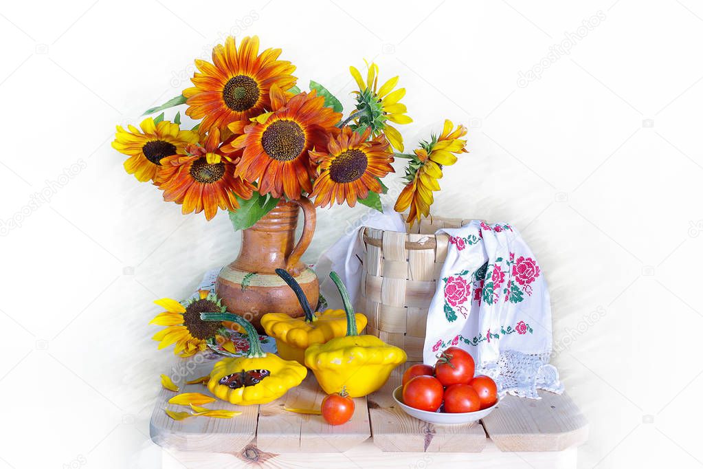 Still life with a bouquet of sunflowers, tomatoes, pumpkins and a beautiful towel in the basket