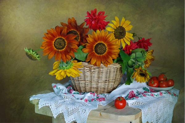 Still life with sunflowers in a basket with embroidered flowers on a towel