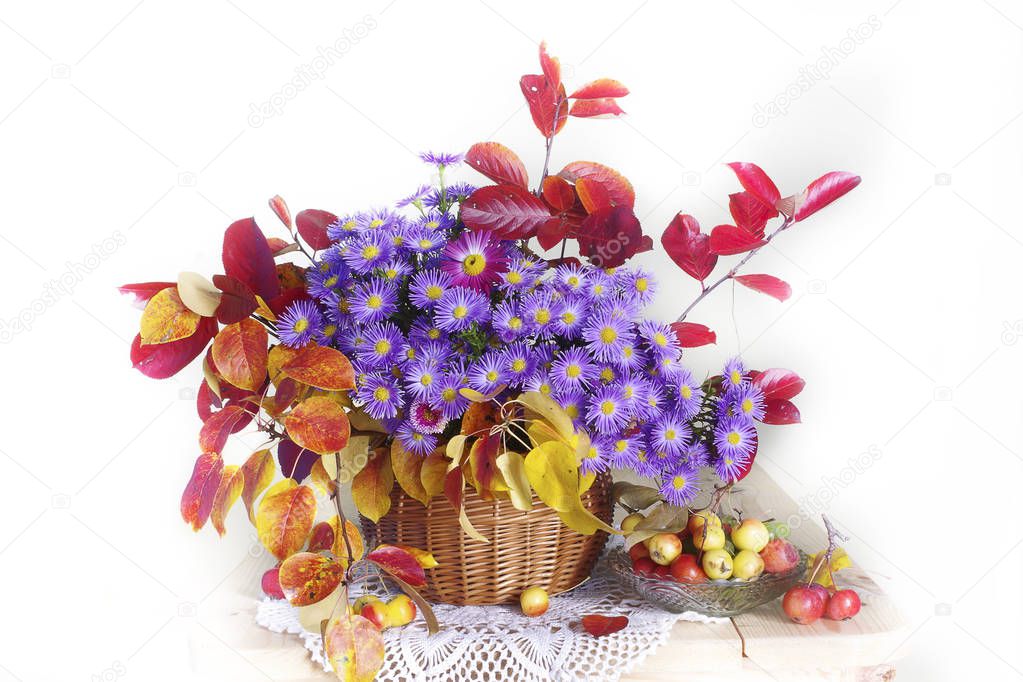 Bouquet with autumn leaves and blue flowers on a white background