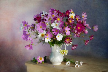 Still life with pink daisies in a vase on the table. clipart