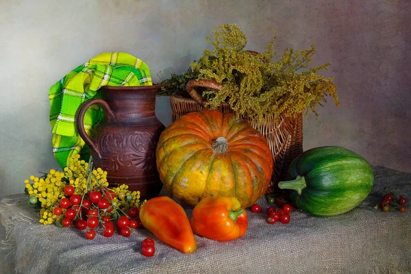 Autumn thanksgiving background, seasonal autumn berries, pumpkins, apples and flowers on a wooden table.Background of the thanksgiving holiday. Still life with the Thanksgiving concept