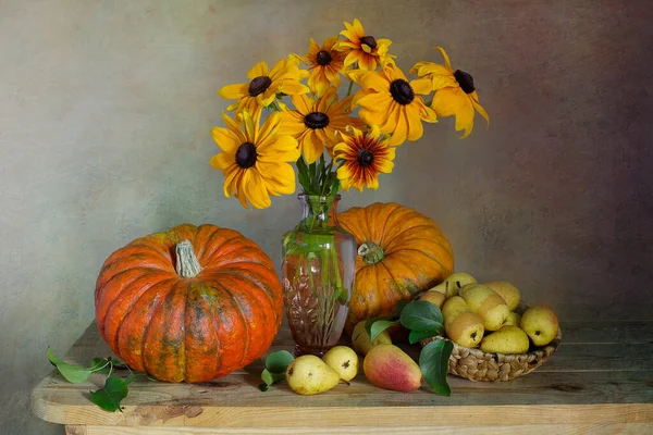 Autumn thanksgiving background, seasonal autumn berries, pumpkins, apples and flowers on a wooden table.Background of the thanksgiving holiday. Still life with the Thanksgiving concept