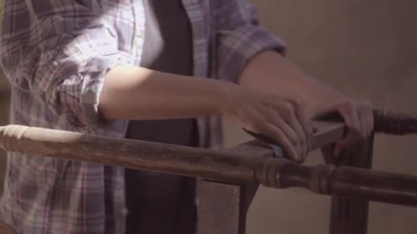 The carpenter girl works in the workshop, restored vintage furniture — Stock Video
