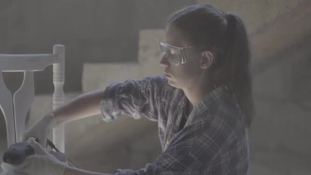 Girl carpenter, designer, works with electric tool — Stock Video