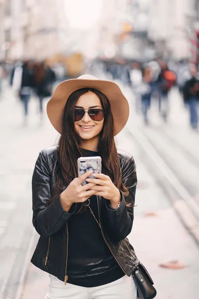 トルコのイスタンブールで携帯電話を使用して茶色の帽子でスタイリッシュな女の子 — ストック写真