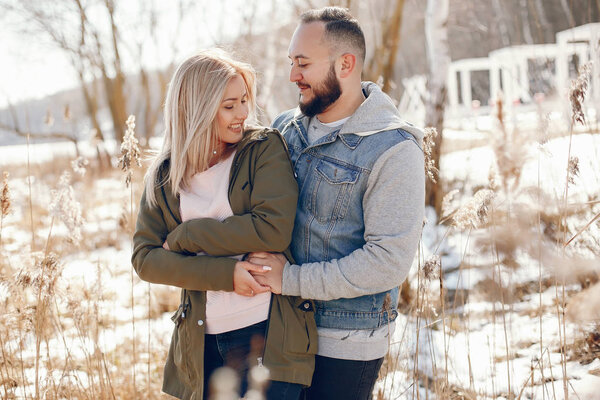 Elegant couple in a winter park