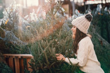 Beyaz süveter ve Noel ağacı içinde tatlı bir esmer.