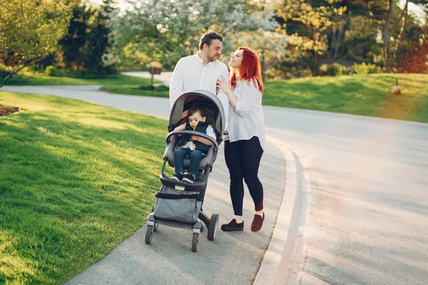 Cute family in a sunny park — Stock Photo, Image