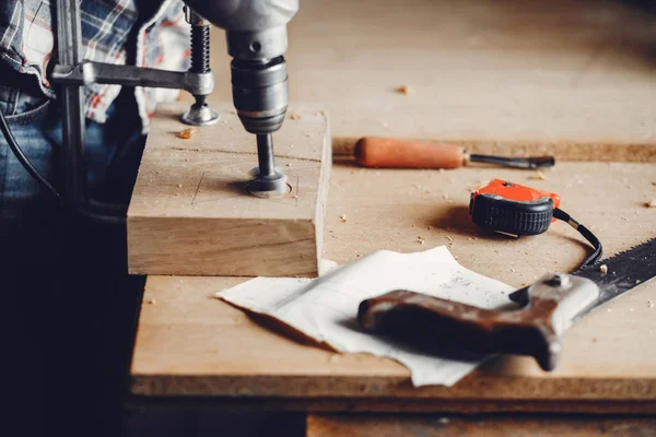 The carpenter works with a tree