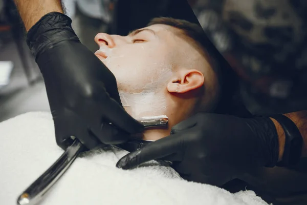 El hombre se corta la barba en la barbería. —  Fotos de Stock