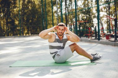 Parkta yakışıklı bir adam. Spor giyimli bir sporcu. Erkek eğitimi 