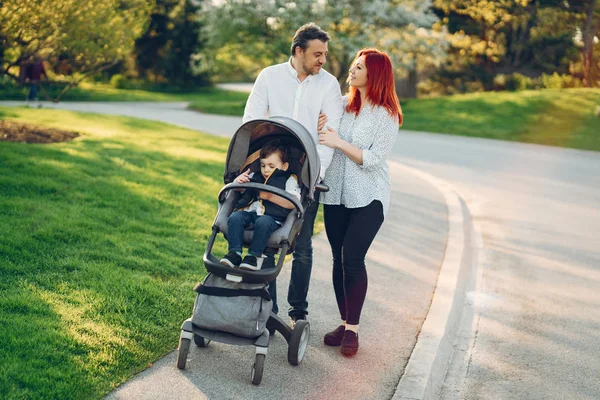 Cute family in a sunny park — Stock Photo, Image