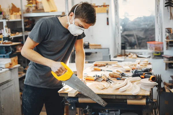 The carpenter works with a tree