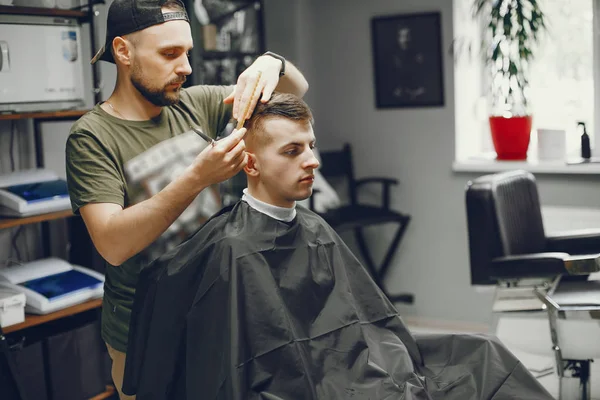 A man cuts hair in a barbershop