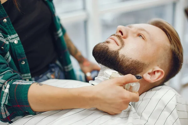 Stylish man sitting in a barbershop — Stock Photo, Image