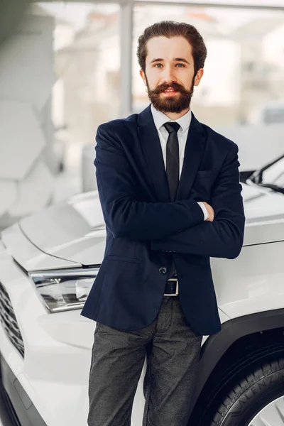 Hombre guapo y elegante en un salón de coches —  Fotos de Stock