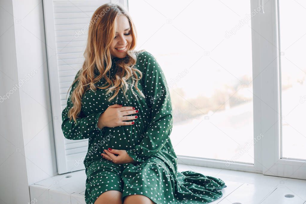 Beautiful young pregnant woman at home