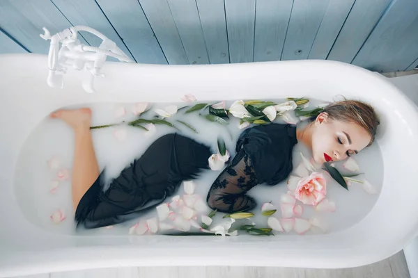 Stylish and beautiful girl lies in the bathroom — Stock Photo, Image