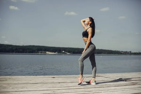 Beautiful sports girl in a summer park — Stock Photo, Image