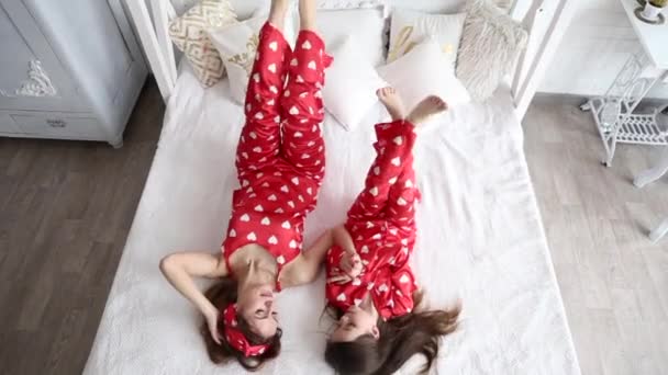 Vídeo de la madre y la hija jugando en el dormitorio en pijama a juego — Vídeo de stock