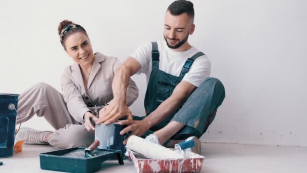 Casal feliz pintando seu primeiro apartamento juntos — Vídeo de Stock