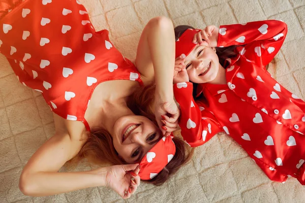 Carino madre e figlia a casa in pigiama — Foto Stock