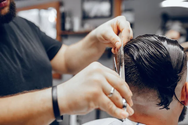 Stylish man sitting in a barbershop — Stock Photo, Image