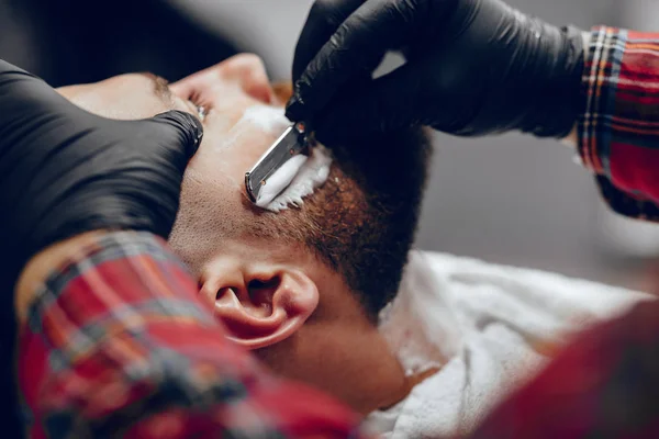 stock image Stylish man sitting in a barbershop