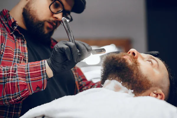 Stilvoller Mann sitzt in einem Friseurladen — Stockfoto